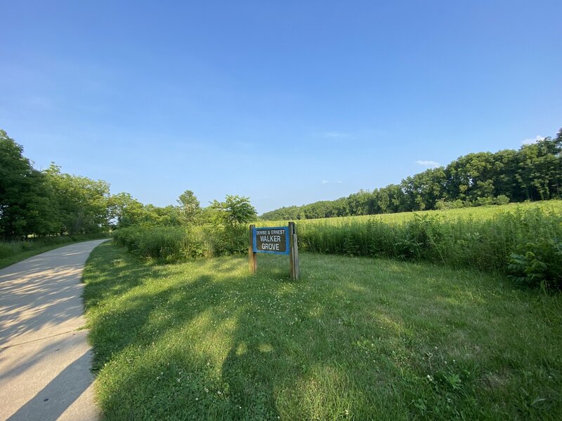 Paved path going by sign that says "Denise & Ernest Walker Grove".