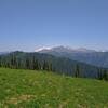 The meadows at the top of Cady Ridge, other nearby ridges, and Glacier Peak, 10.541 ft. (center left), in the distance to the north.