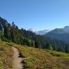 Glacier Peak, 10,541 ft., (center) peeks out ahead to the north in the distance at the PCT/Cady Ridge Trail junction.