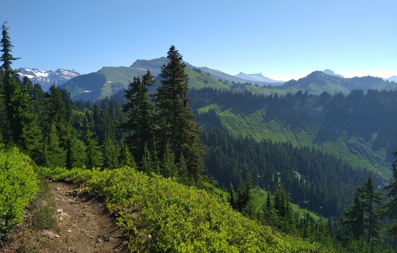 Heading north on the PCT nearing Dishpan Gap, the headwaters of the Little Wenatchee River flow down the drainage to the right/east.