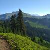 Heading north on the PCT nearing Dishpan Gap, the headwaters of the Little Wenatchee River flow down the drainage to the right/east.