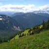 The mountains stretch far into the distance when looking west from the hillside meadows of Johnson Mountain Trail.