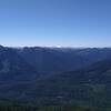 Snow covered Mt. Rainier, 14,411 ft., in the far distance (center right) is constantly in the view to the southwest along Little Wenatchee Ridge Trail.