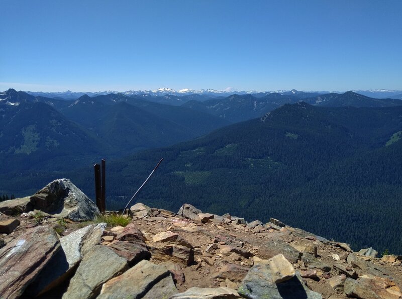 Distant mountains, including snow covered Mt. Rainier, 14,411 ft. (center right), Are seen looking southwest from the Poe Mountain summit - 6,015 ft.