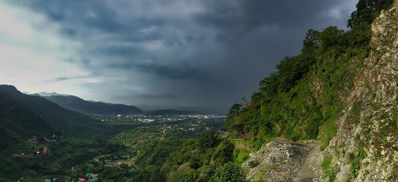 Gravel-surfaced top of the initial steep section of the Rajpur-Jharipani Hiking Trail. The Rispana river catchment and eastern Doon Valley visible beyond.