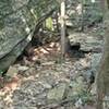 Path over a rock shelf between tumbled limestone outcropping.