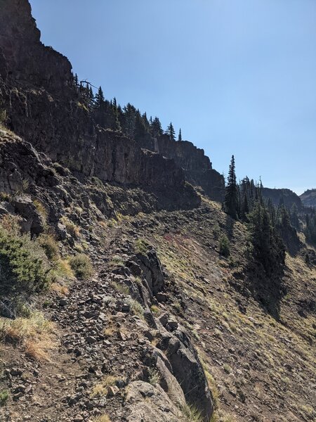 The trail carved into side of the hill, often narrow, narrow slippery tread on trail.