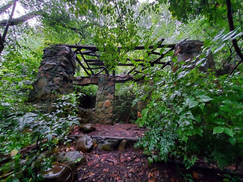 An abandoned structure that's been added on to by passersby.