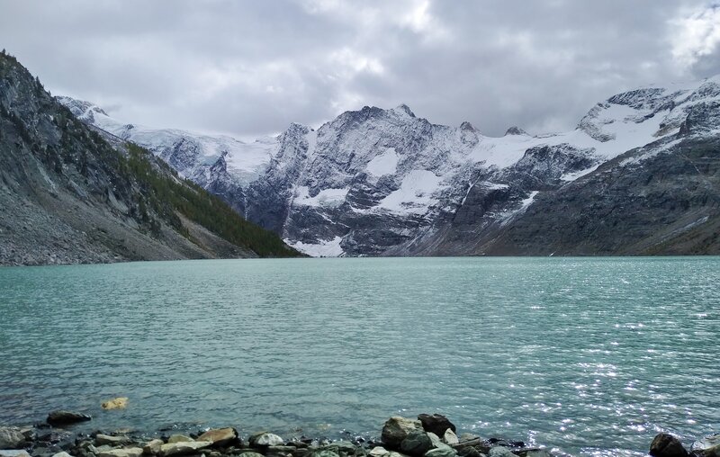 Lake of the Hanging Glacier from its north shore. Jumbo Glacier is just left of the peak in the center.  The ridge of peaks stretching west/left from the center, are the Lieutenants.