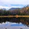 Lily Pad Lake in early fall with the aspen in gold and the mountains just kissed with snow.