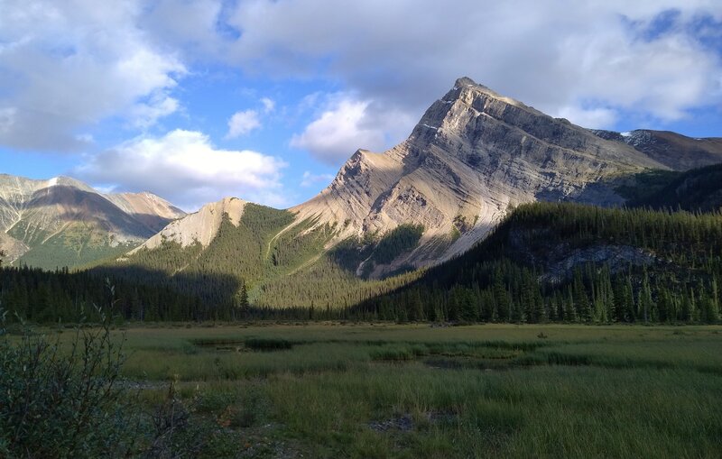 A very photogenic unnamed mountain across meadows and the Snake Indian River, to the southeast of Three Slides trail camp.