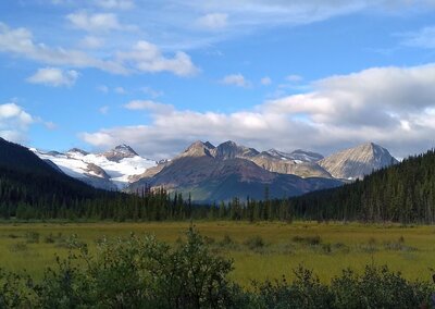 Upright Mountain, 9,771 ft., is the snowy mountain on the left. Treadmill Ridge runs from Upright Mountain to the right. Some of Treadmill Ridge is hidden behind closer peaks. This is the view to the southwest from Three Slides trail camp.