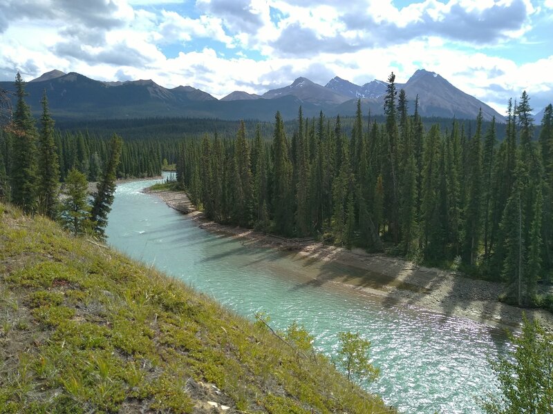 Beautiful, turquoise Snake Indian River and rugged mountains into the distance in the North Boundary Trail backcountry.