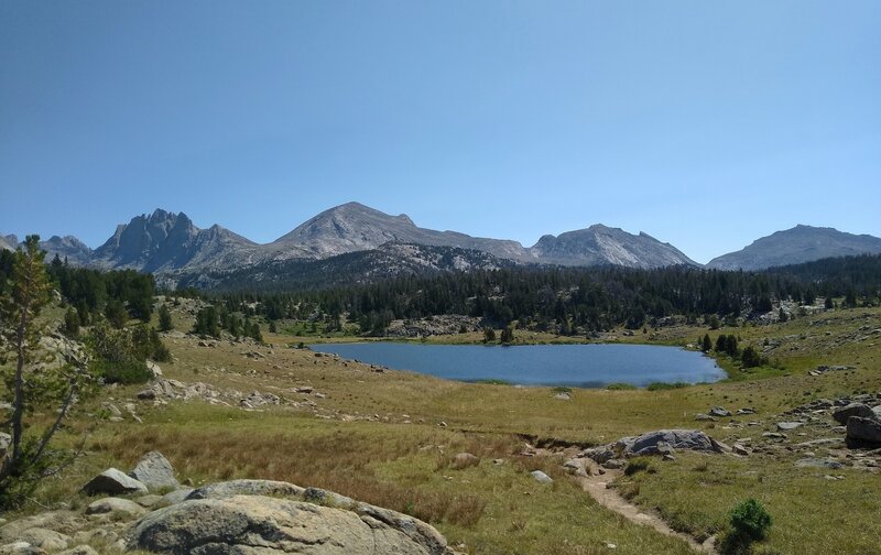 Yet another pretty little lake in the alpine meadows beneath the Continental Divide to the east.  Mountains (left to right) are Mt. Bonneville, 12,585 ft., Raid Peak, 12,532 ft., unnamed, Mt. Geikie, 12,378 ft.