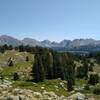 The high rocky, grass meadows of the Wind Rivers. The three peaks in the center in the far distance are the back/west side of Cirque of the Towers.