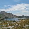 Looking back/southwest at Lake 10542 in the rocky, grassy alpine meadows when heading to the third lake, Lake 10741, on the way to Europe Pass.