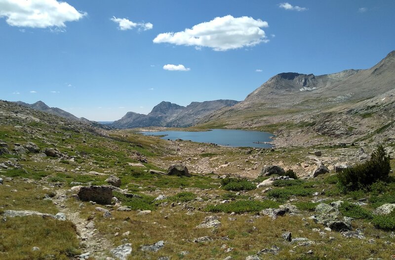 Beth Lake (Lake 10755). Mt. Victor, 12,254 ft., pokes up on the left, the pointy peak (center left) is North Fork Peak, 11,175 ft., and the nearby mountain on the right is Round Top Mountain, 12,048 ft. Looking south at Hay Pass.