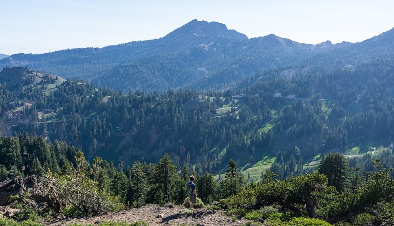 A hiker looking towards Brokeoff Mountain across the valley.