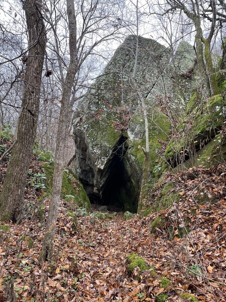 The trail continues through the crack in this boulder.