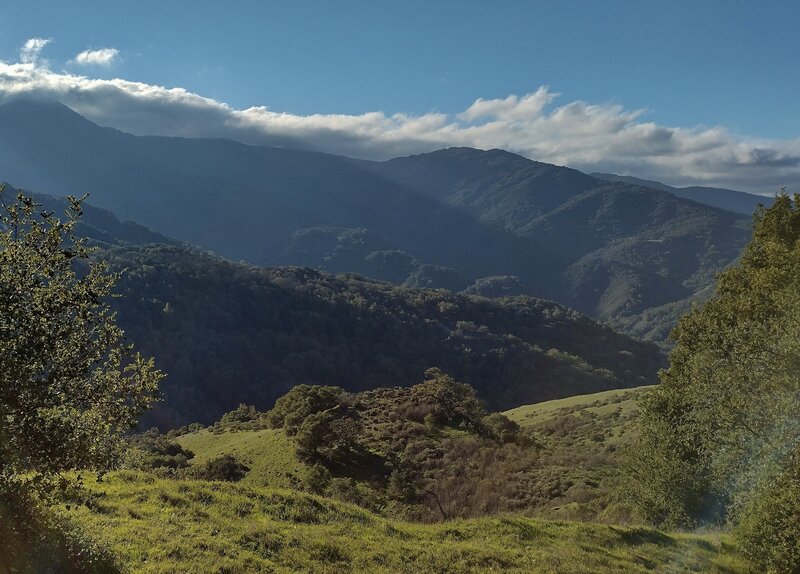 The Santa Cruz Mountains with Mt. Umunhum, 3,489 ft., at the far left, its summit in the clouds.  Seen looking southwest on Castillero Trail on a bright, crisp December afternoon.