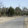 Headed east near S. MacArthur Blvd. in this wintertime photo the close-in trees keep the winds to a minimum for most of the 7.5 mile trail.