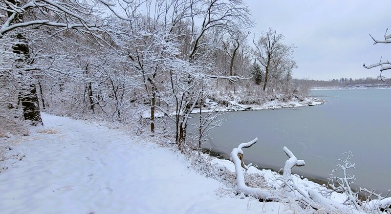 Trail along the edge of the lake with an inch of snow covering all