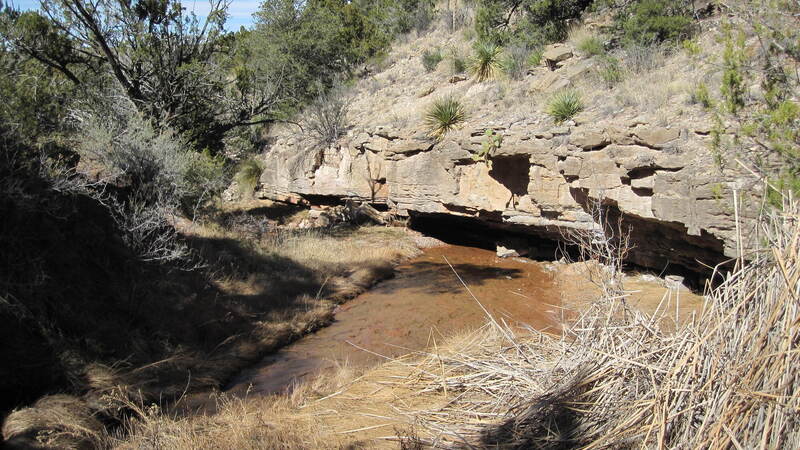 Above the falls, below the bridge.