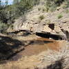 Above the falls, below the bridge.