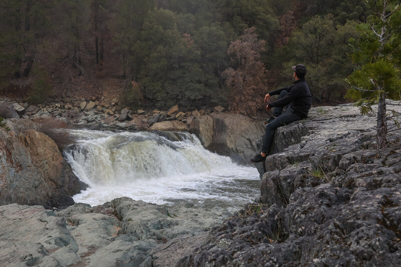 Perched on the boulders overlooking the waterfall