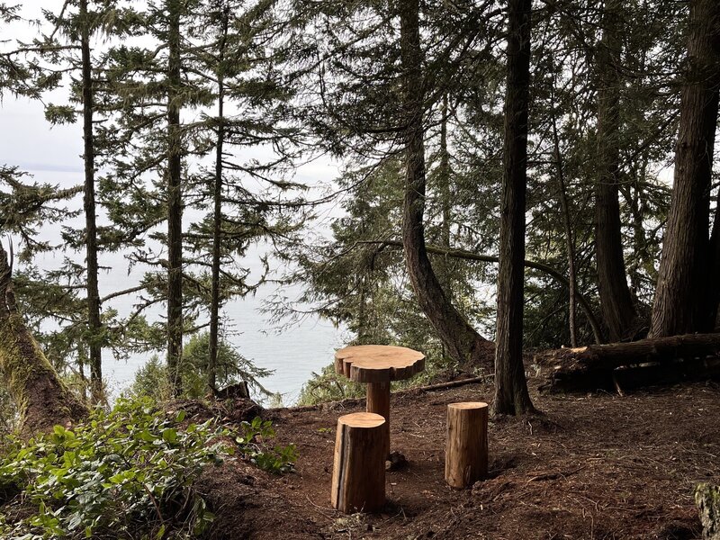 Wooden table and chairs approaching Striped Peak summit.