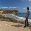 A trailside viewpoint of Sacred Cove Beach just before descending to it.