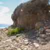 Stone steps along the trail descend into a small wash, which leads to Sacred Cove Beach.