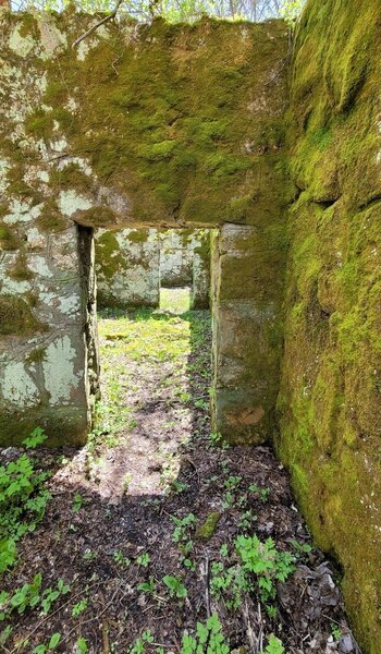 Abandoned homestead with thick concrete and block walls and numerous rooms