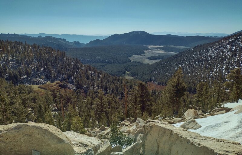 Looking southeast into the far distance from Cottonwood Pass. The forested hills and meadows of Golden Trout Wilderness are seen below.