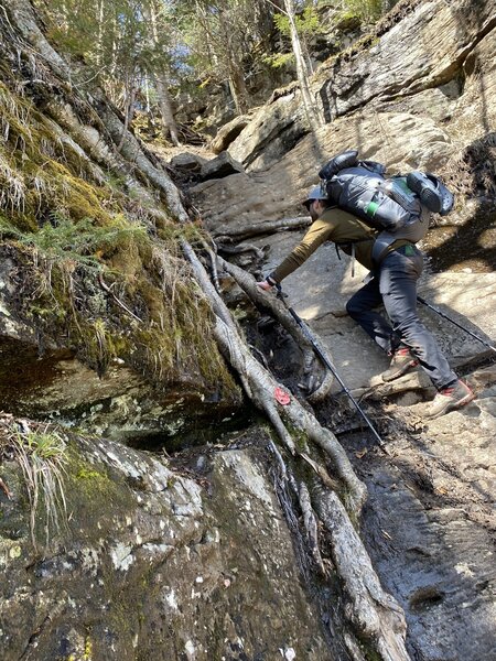 A hiker climbs a steep section of Devil's Path.