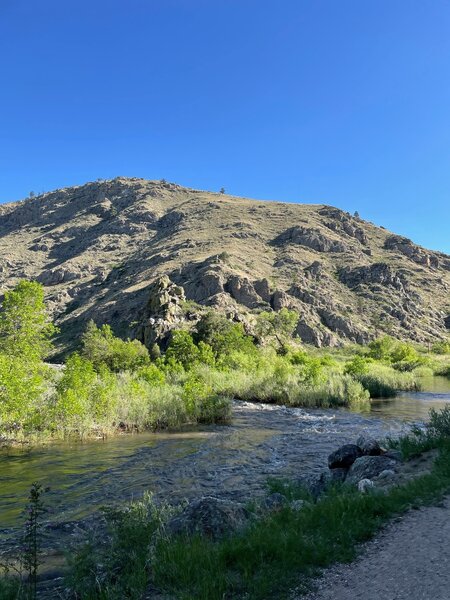 Hills and river next to trail.