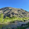 Hills and river next to trail.