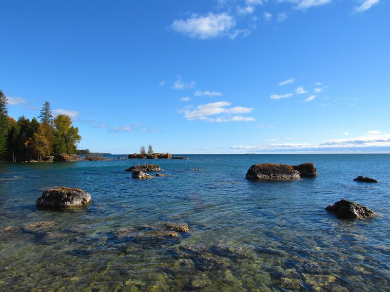 A view of Lake Huron with some fall foliage.