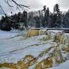 Mostly-frozen Tahquamenon Falls in winter from the primary viewing platform.