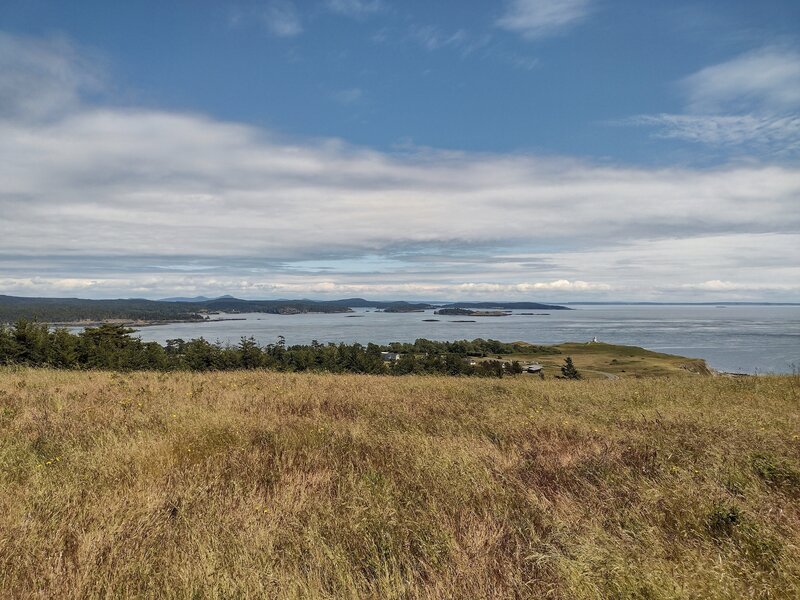 San Juan Islands and lighthouse in the distance on the southeastern point of San Juan Island.