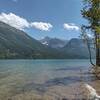 Rugged mountains across Upper Waterton Lake near the Canada/USA border, seen looking southeast from a small beach along Lakeshore Trail.