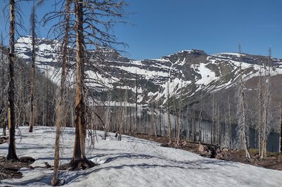 Cameron Lake is below the Carthew Alderson Traverse trail on a clear, late June morning, of a high snow pack year.