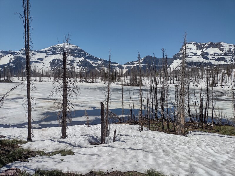 Amid all the snow, is the still ice and snow covered Summit Lake, 4 days before Canada Day - July 1.