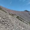 The trail can faintly be seen (up the center) as it traverses shale and scree on its way on the west side, to the saddle between Mt. Carthew and Mt. Alderson