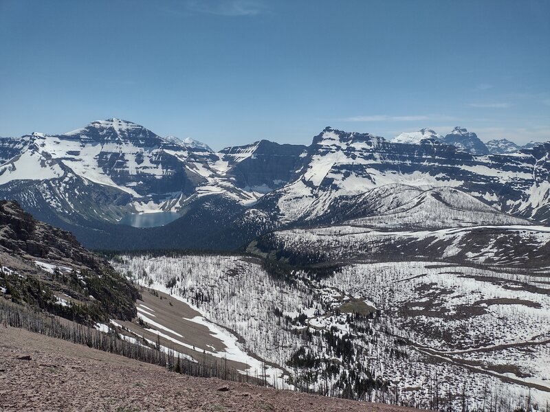 Chapman Peak (left), Lake Wurdeman, Lake Nooney, and Mt. Custer (center right) rise among a sea of peaks when looking south from the shoulder of Mt. Carthew, almost July of a high snowpack year.
