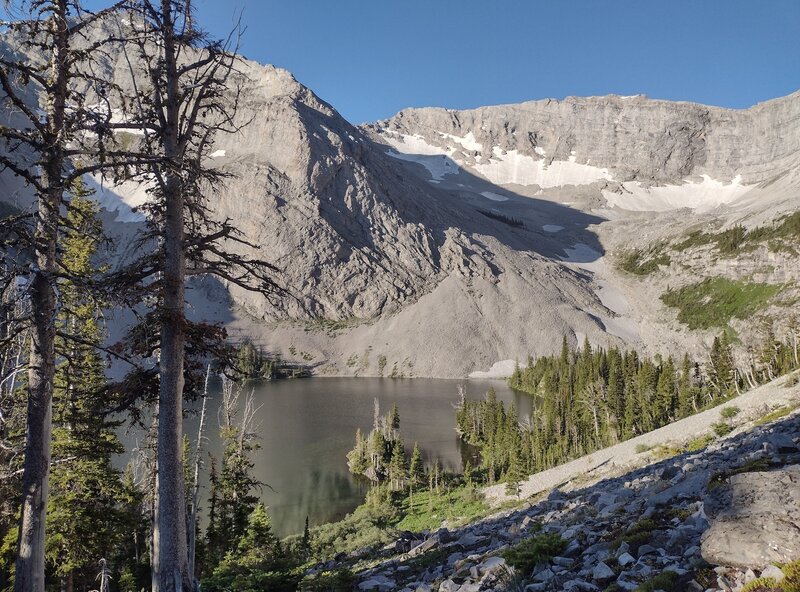 Looking down on Window Mountain Lake from the switchbacks on its north slope.  Behind the trees on the left is Mt. Ward. The rock wall on the right is part of the Great Divide.