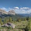 Seven Sisters, named for its seven spires on its top ridge, is on the left. Crowsnest Mountain is just left of center.  Seen looking southeast as the trail crests a ridge just below the Great Divide.