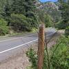 Trailhead to left.  Post where trailhead sign used to be. Mile marker 293 in background to right of post.