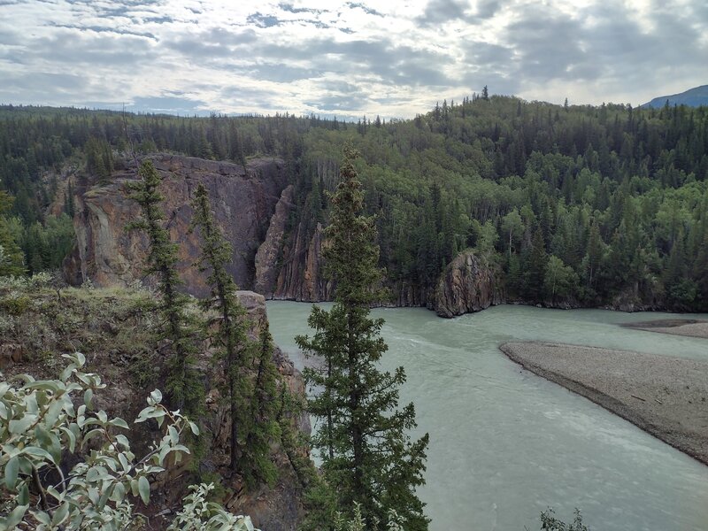 The Smoky River flowing towards the Sulphur Gates cliffs, left-center.