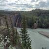 The Smoky River flowing towards the Sulphur Gates cliffs, left-center.